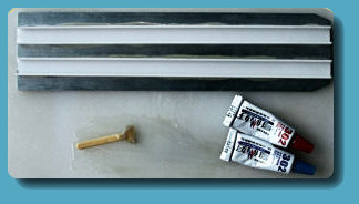 Strip holders glued to the aluminium
